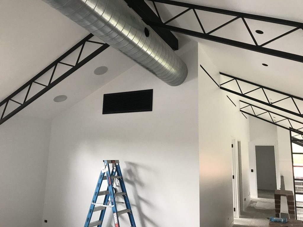 Ducted air conditioning system with exposed spiral duct and return grille